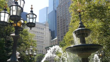 New York City Lower Manhattan, Downtown Financial District architecture, United States. High-rise buildings on Broadway street, USA. American urban scene, fountain in City Hall Park, NYC. Greenery. clipart