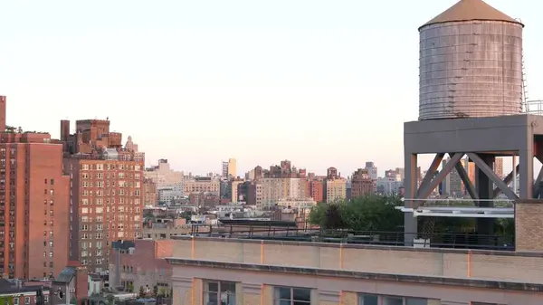 stock image New York City Manhattan skyline cityscape. Rooftop view point, residential district buildings roofs. Real Estate, urban architecture, United States streets. Midtown Chelsea district. Water tower tank.