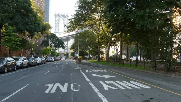 stock image Manhattan Bridge to Brooklyn Dumbo. New York City symbol, USA travel destination. Cable-stayed bridge from Two Bridges residential district, Manhattan. Cars on street crossroad, roads intersection.