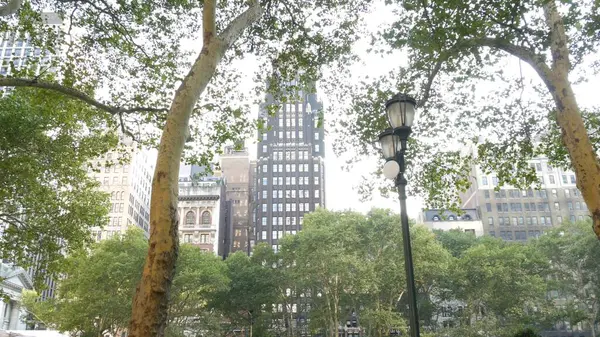 stock image New York City, Manhattan Midtown Bryant Park with Public library, 42 street and 5th Fifth 5 avenue corner, United States. NYC landmark in USA. Trees summer greenery in public park garden. Buildings.