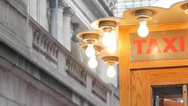 stock image New York City, American Grand Central Terminal railway station building architecture, 42 street. Manhattan Midtown. Yellow taxi kiosk, telephone call box with bulb lights on Pershing Square, NYC, USA.