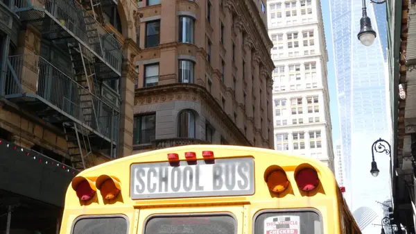 stock image Yellow School Bus. Schoolbus back view on Fulton street, New York City Manhattan Downtown. Children education and transportation, USA. American school shuttle, World Trade Center tower, United States.