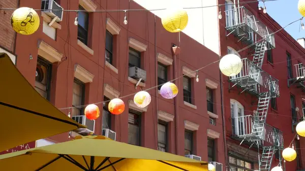 stock image New York City, United States. Manhattan Chinatown Doyers street, chinese ethnic district building architecture, USA. Brick houses, round paper lanterns, little China town. American fire escape ladder.