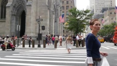 New York, ABD - 11 Eylül 2023: Manhattan Midtown Caddesi, Beşinci Cadde, 5. Cadde, Amerikan şehir trafiği, ABD 'de sarı taksi. Patricks Katedrali. İnsanlar zebra üzerinde yayalar