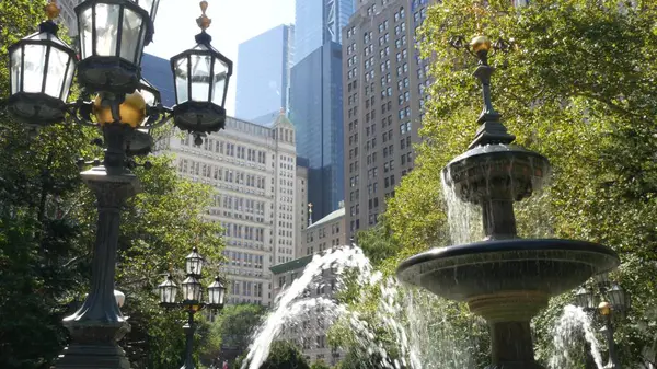 stock image New York City Lower Manhattan, Downtown Financial District architecture, United States. High-rise buildings on Broadway street, USA. American urban scene, fountain in City Hall Park, NYC. Greenery.