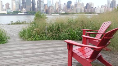 New York City waterfront skyline, Manhattan Midtown buildings, riverfront skyscrapers by East river water. Waterside cityscape view, Gantry Plaza Park, Long Island, Queens. United States. Chair bench. clipart