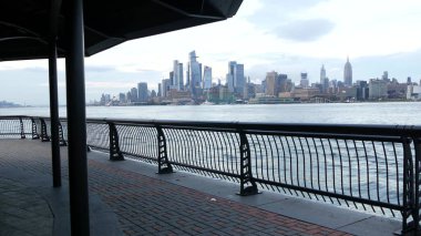 New York City rıhtımı, Manhattan Midtown Hudson Yards binaları, nehir manzaralı gökdelenler. Hoboken, New Jersey 'deki Pier A Park' tan rıhtım manzarası. Birleşik Devletler mimarisi. Hudson Nehri.