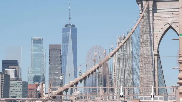 stock image Brooklyn Bridge to Manhattan downtown, cables and blue sky. New York City skyline, financial district cityscape. World Trade Center, USA travel destination. Architecture of United States of America.