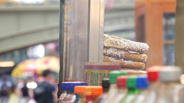 New York City life, Manhattan Midtown 42 street. Fast food hot dog, street food kiosk. Defocused people pedestrian near Grand Central Terminal Station, Pershing Square Bridge USA. Precel, hotdog to go clipart