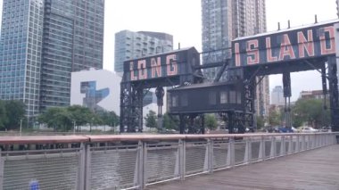 New York City Gantry Plaza rıhtımı, Long Island tabelası, Hunters Point, Queens, ABD. Endüstriyel rıhtım demirden yapılma tarihi tarihi nehir kenarı kenti, Manhattan 'ın karşısındaki East River.