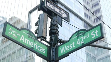 New York City crossroad, 42 street intersection road sign. 6 Sixth ave, Americas avenue corner, Midtown business district, NYC, Bryant park. Highrise skyscraper architecture, one way text roadsign. clipart