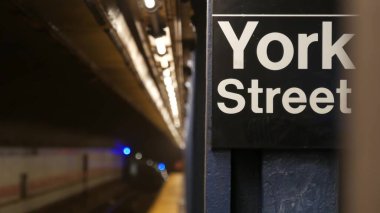 New York şehri içi boş metro istasyonu, yeraltı metro platformu tabelası. Metro demiryolu yolcusu toplu taşıma, Birleşik Devletler. Bakış açısı. York Caddesi 'ndeki yazı tahtası. Brooklyn Şehir Merkezi