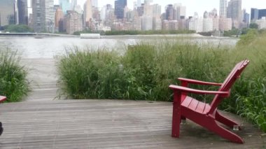 New York şehri kıyısı silueti, Manhattan şehir merkezi binaları, nehir kıyısındaki gökdelenler, doğu nehri suyu. Liman kenti manzarası, Gantry Plaza Park, Long Island, Queens. Birleşik Devletler. Koltuk sırası..