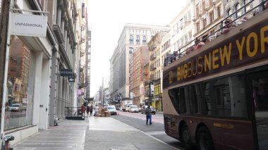 New York City, United States - 8 Sept 2023: Manhattan Soho District Broadway street perspective. Fashion stores for shopping. Tourists on sightseeing double-decker Big Bus. People on two-storey Bigbus clipart