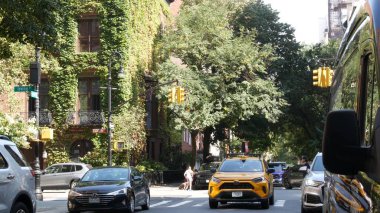 New York City, ABD, 6 Eylül 2023 Manhattan şehir merkezi Irving sokak köşesi, kavşak, Gramercy, ABD. İnsanlar yayalar. Sarı taksi. Sarmaşık yapraklarıyla kaplı kırmızı tuğladan ev