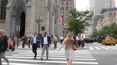 New York City, United States - 11 Sept 2023: Manhattan Midtown street, Fifth 5 avenue, 5th ave, American urban road car traffic, Yellow taxi cab in USA. Patricks Cathedral. People pedestrians on zebra clipart