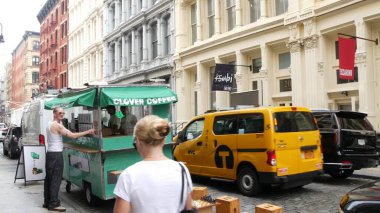 New York, ABD - 8 Eylül 2023: Manhattan Soho moda bölgesi Broadway caddesi yakınlarında. Amerikan şehir binası cephesi, eski klasik Amerikan mimarisi. New York 'tan alışveriş. Millet, sarı taksi.