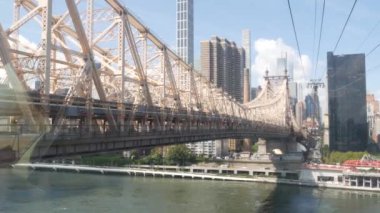 New York City Roosevelt Adası tramvayı Manhattan Midtown sokaklarına gidiyor. Queensboro Köprüsü yakınlarındaki Amerikan tramvayı. ABD 'de toplu taşıma. Yukarı doğu yakası mimarisi, ufuk çizgisi şehir manzarası.