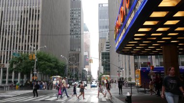 New York, United States - 10 Sept 2023: Manhattan Midtown street. Radio City Music Hall, Rockefeller Center, USA landmark. People pedestrian and urban traffic on 6 Sixth Americas avenue crossroad, NYC clipart