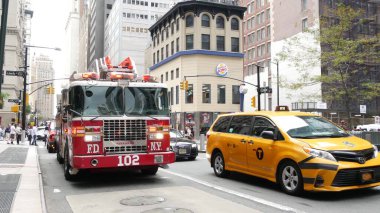 New York City, United States - 11 September 2023: Firefighters celebrate Patriot Day. 911 memorial remembrance, FDNY truck or Fire Department Engine. Manhattan Downtown Greenwich street. Yellow taxi. clipart