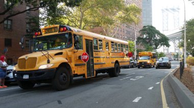 New York, Birleşik Devletler - 7 Eylül 2023: Sarı Okul Otobüsü, Manhattan Köprüsü, okul otobüsü kamyonu, şehir sokağı. Çocuk eğitimi ve Amerikan ulaşımı. Amerikan yerleşim bölgesi okul servisi.