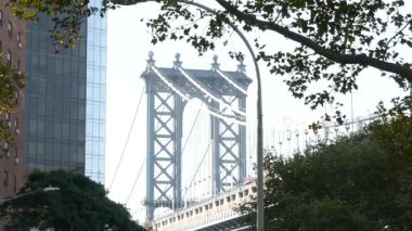 Manhattan Köprüsü 'nden Brooklyn Dumbo' ya. New York 'un sembolü, Amerika' nın seyahat yeri. Amerika Birleşik Devletleri 'nin mimarisi, turist simgesi. Kablolu yayın köprüsü. Kablolar, gökyüzü, park ağacı yaprakları..