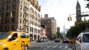 New York, ABD - 10 Eylül 2023 Manhattan Greenwich Village Caddesi, 6. Amerika Bulvarı kavşağı. Yol trafiği, sarı taksi. Amerikan Dünya Ticaret Merkezi. Jefferson Pazar Kütüphanesi.
