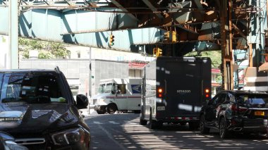 New York, Birleşik Devletler - 31 Ağustos 2023 Sokağın yukarısındaki metro. Yolun üzerindeki Metropolitan Köprüsü, Queens. Long Island metro hattı, Court Meydanı. Amazon, USPS kamyonu rayların altında. Lokanta Kafe