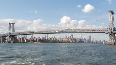 Feribottan New York City silueti. Manhattan şehir merkezindeki gökdelenler feribottan görünüyor. Doğu nehri kıyısı manzarası, nehir kıyısındaki binalar ABD suları yakınında. Williamsburg Köprüsü