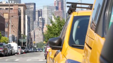 New York 'ta. Queens caddesindeki sarı taksiler. Long Island, LIC 'de bir sürü taksi var. Madalyon taksi ve Manhattan şehir merkezi şehir merkezi silueti. Yüksek binalı mimari.