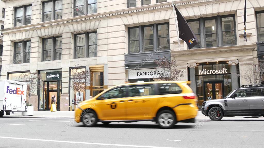 New York City, United States - 8 Sept 2023: Manhattan Midtown street, Fifth 5 avenue. American urban road car traffic. Yellow taxi cab in USA. People pedestrians. Boutique fashion stores for shopping