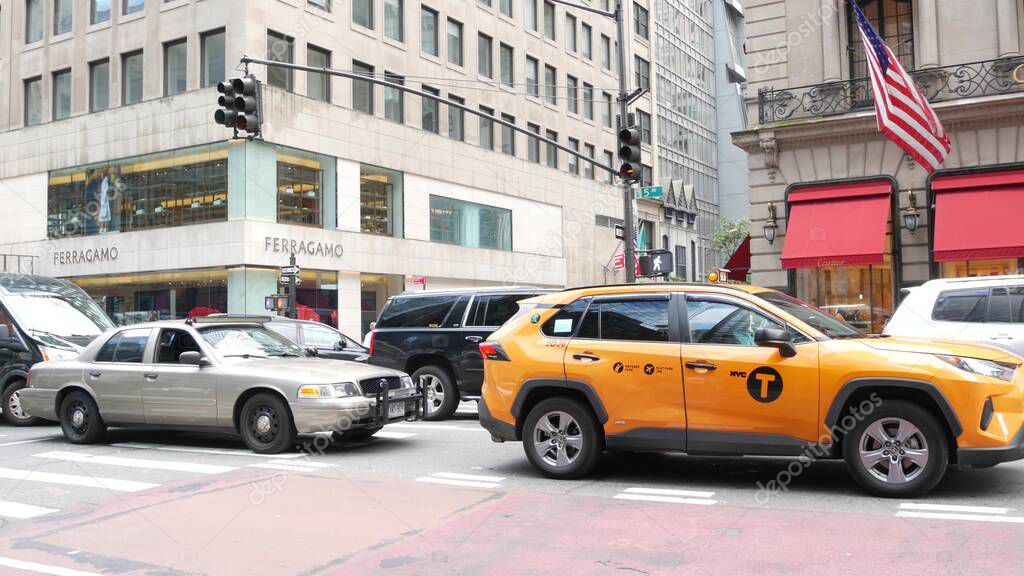 New York City, United States - 13 Sept 2023: Manhattan Midtown street, Fifth 5 avenue. American urban road car traffic. Yellow taxi cab in USA. People. Boutique fashion stores for shopping. Cartier.