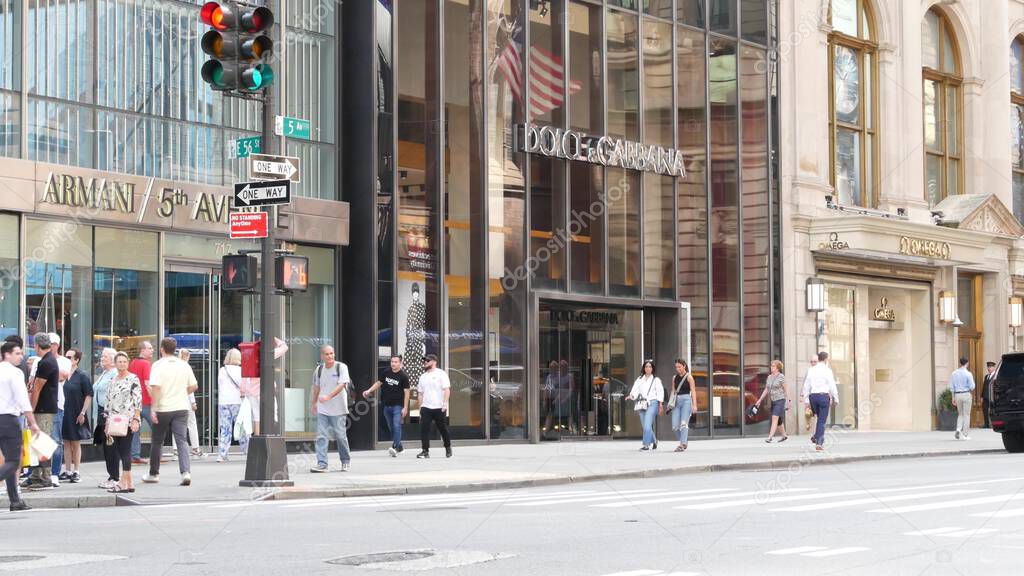 New York City, United States - 11 Sept 2023: Manhattan Midtown street, Fifth 5 avenue. American urban scene, USA. People pedestrians on sidewalk pavement. Boutique stores for luxury fashion shopping.