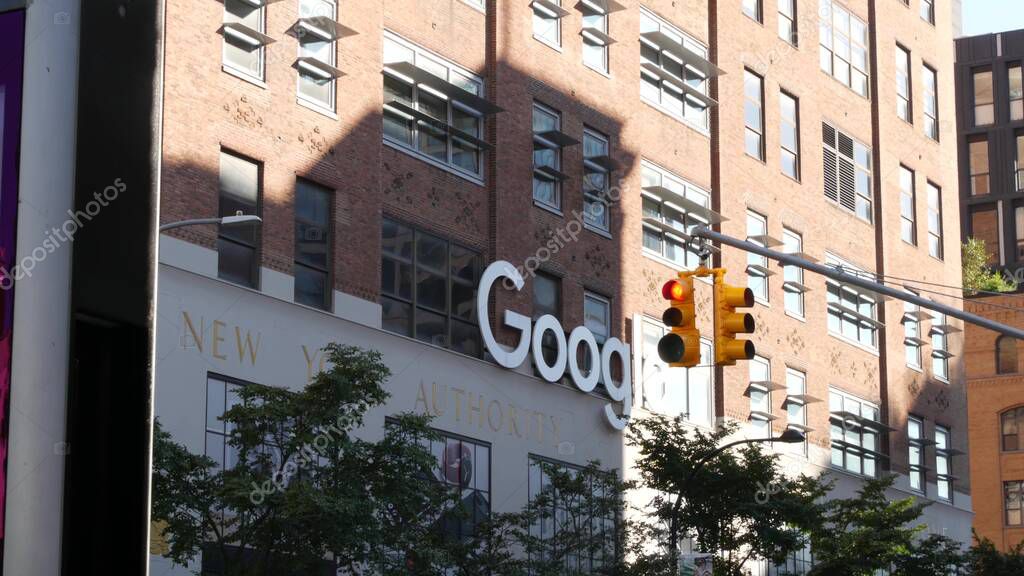 New York City, United States - 1 Sept 2023: Manhattan Midtown street or avenue. Urban red brick architecture USA. Google logo. Headquarters office near Chelsea Market, High Line. Yellow traffic light.