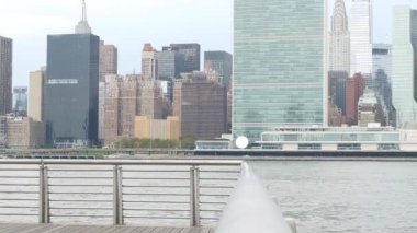 New York şehri kıyısı silueti, Manhattan şehir merkezi binaları, nehir kıyısındaki gökdelenler, doğu nehri suyu. Liman kenti manzarası, Gantry Plaza Park, Long Island, Queens. Birleşik Devletler mimarisi.