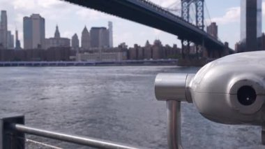 New York City Manhattan Köprüsü gözcüsü, kule görüntüleme dürbünü, Brooklyn, Dumbo, ABD. Şehir merkezinde rıhtım manzarası, finansal bölge gökdeleninin silüeti. Riverfront turizm güvertesi, East River.