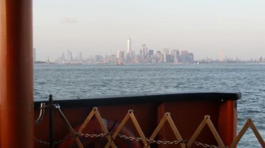 New York City feribottan Staten Island 'a ufuk çizgisi. Manhattan şehir merkezinde. Feribottan Dünya Ticaret Merkezi gökdelenine. Nehir kıyısı günbatımı manzarası, nehir kenarındaki binalar, Fidi, ABD