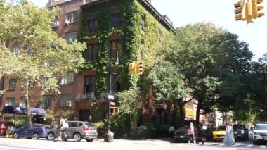 New York City, ABD, 6 Eylül 2023 Manhattan şehir merkezi Irving sokak köşesi, kavşak, Gramercy, ABD. İnsanlar yayalar. Sarı taksi. Sarmaşık yapraklarıyla kaplı kırmızı tuğladan ev