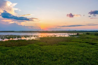 Aerial view of Mobile Bay and Daphne, AL at sunset in September 2022