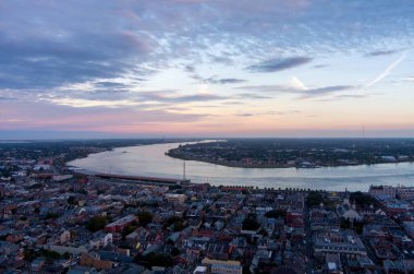 Aerial view of downtown New Orleans, Louisiana and the Mississippi River at sunset in November clipart