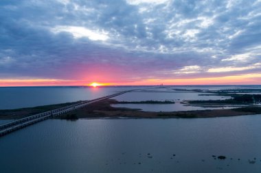 Aerial view of Jubilee Parkway and Mobile Bay at sunset in April on the Alabama Gulf Coast clipart