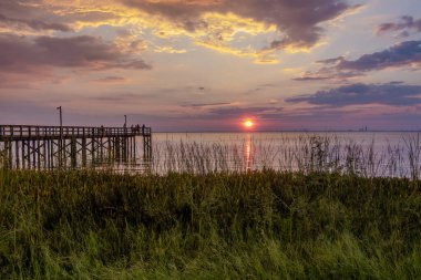 Bayfront Park pier at sunset on the Eastern shore of Mobile Bay in Daphne, Alabama clipart