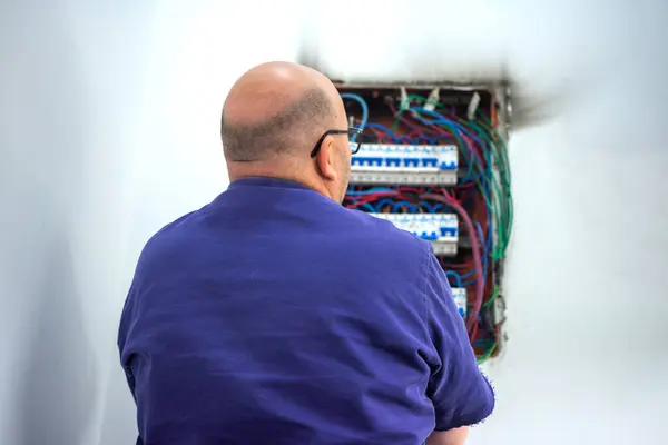 Electrician repairing burnt electrical connection