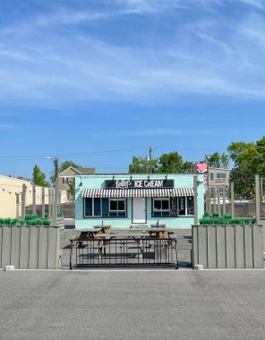 VIRGINIA BEACH, VA - APRIL 20, 2023:  The ViBe location of the delightful locally started, family operated ice cream business Lolly's, early in the morning before opening for the day.  clipart