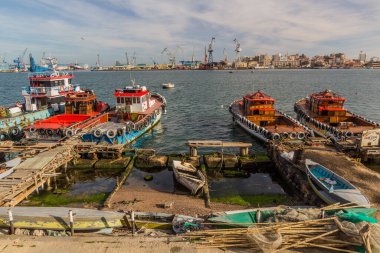 PORT SAID, EGYPT - FEBRUARY 3, 2019: Boats in the Suez canal in Port Said, Egypt clipart