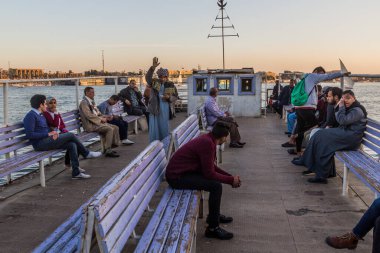 LUXOR, EGYPT - FEB 18, 2019: Passengers of a ferry across the river Nile in Luxor, Egypt clipart