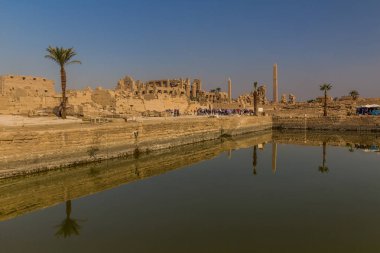 LUXOR, EGYPT - FEB 21, 2019: Sacred lake in the Karnak Temple Complex, Egypt