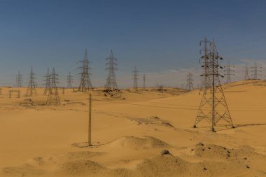 Electric pylons in a desert near Aswan, Egypt