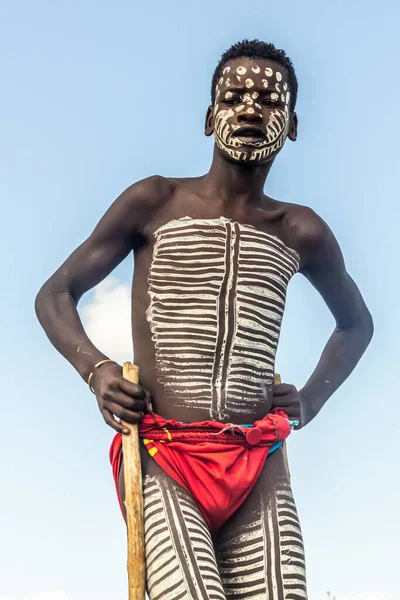 stock image OMO VALLEY, ETHIOPIA - FEBRUARY 5, 2020: Banna tribe boy walking on stilts, Ethiopia