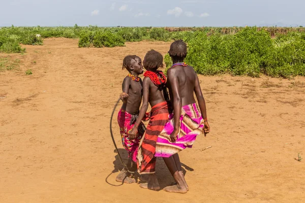 stock image OMORATE, ETHIOPIA - FEBRUARY 5, 2020:  Daasanach tribe girls near their village near Omorate, Ethiopia